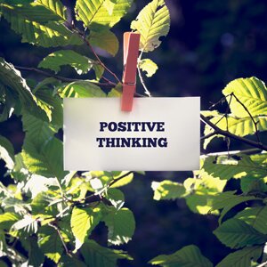 Positive Thinking Message Clipped on Green Plant